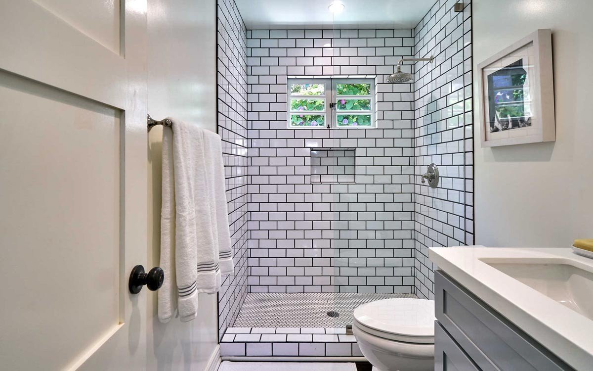 Finished bathroom with subway tile walk-in shower