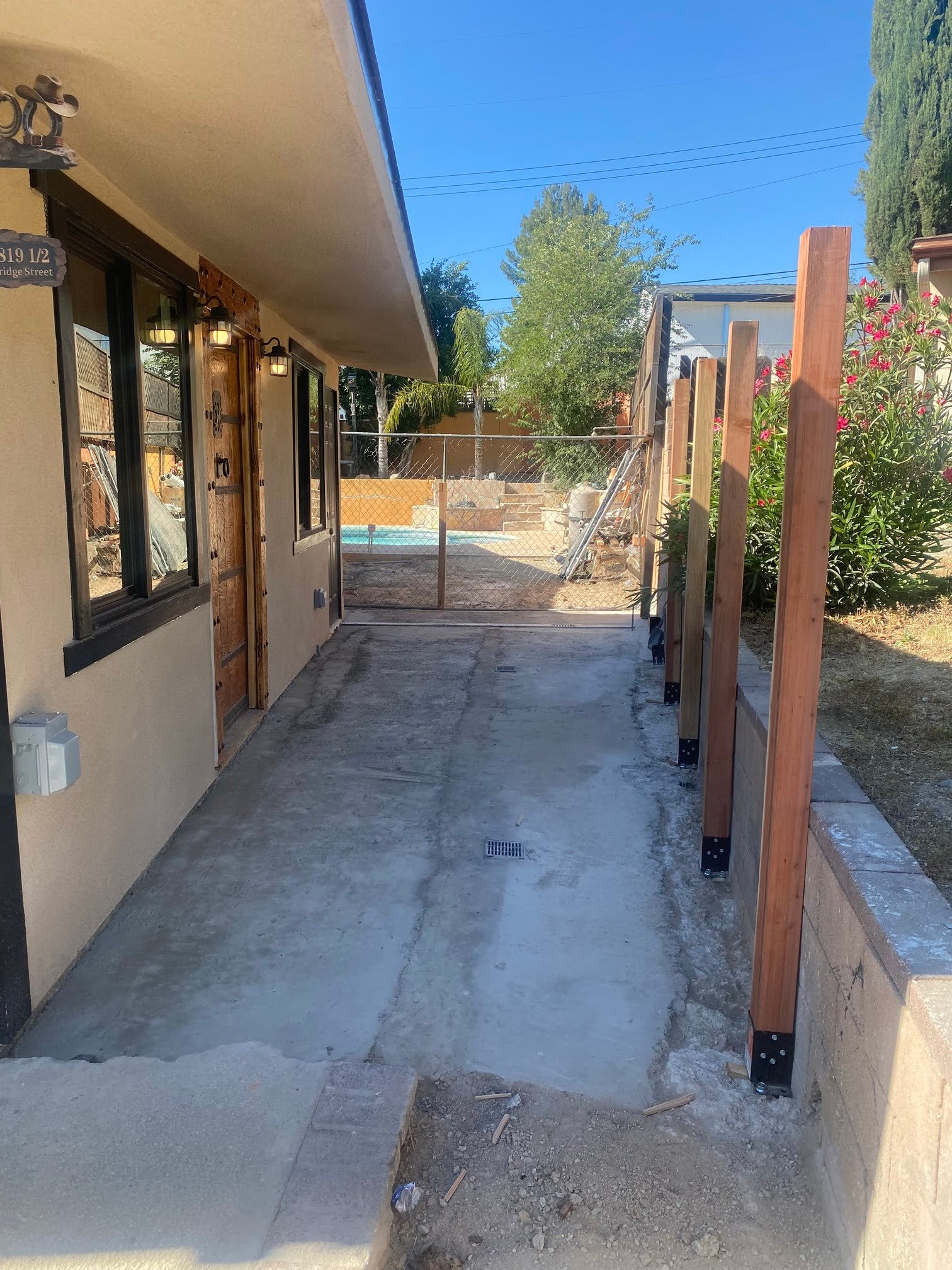 Wood fence posts installed along the side yard